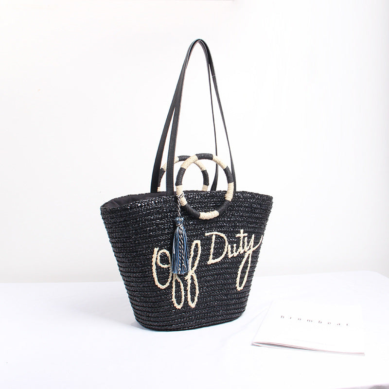 Designer shoulder bag with playful lettering and decorative tassel detail Bowlift