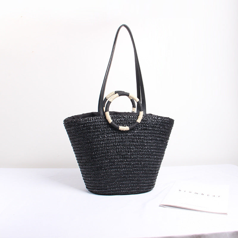 Designer shoulder bag with playful lettering and decorative tassel detail Bowlift