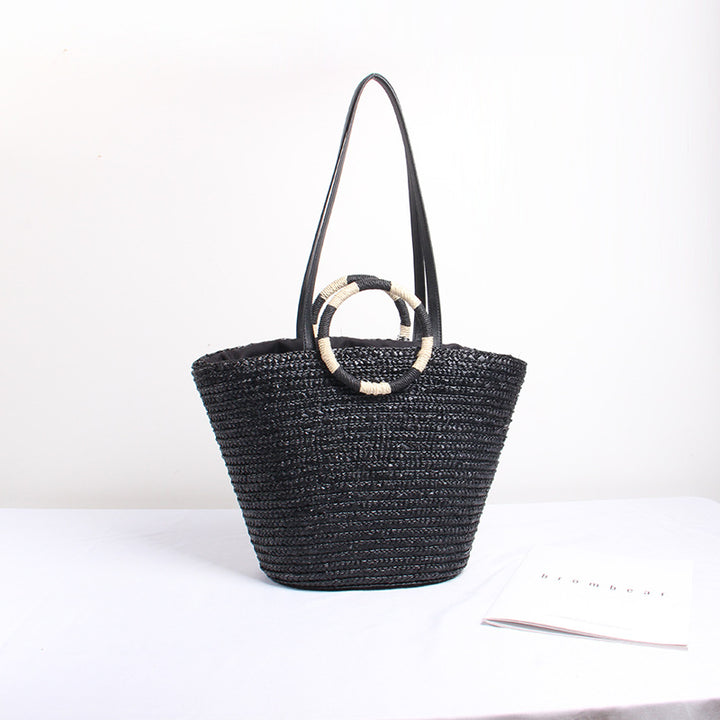 Designer shoulder bag with playful lettering and decorative tassel detail Bowlift