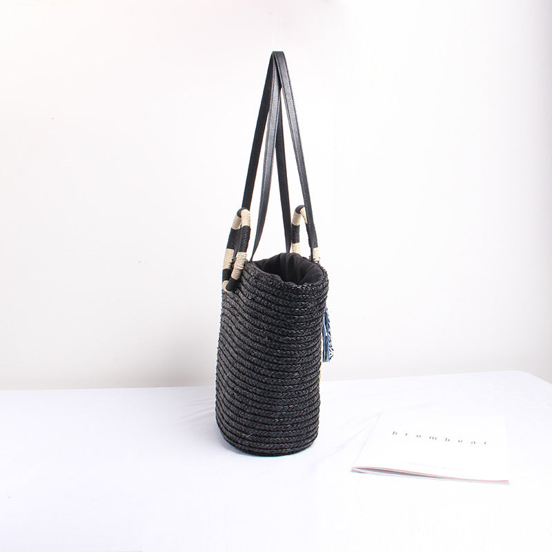Designer shoulder bag with playful lettering and decorative tassel detail Bowlift