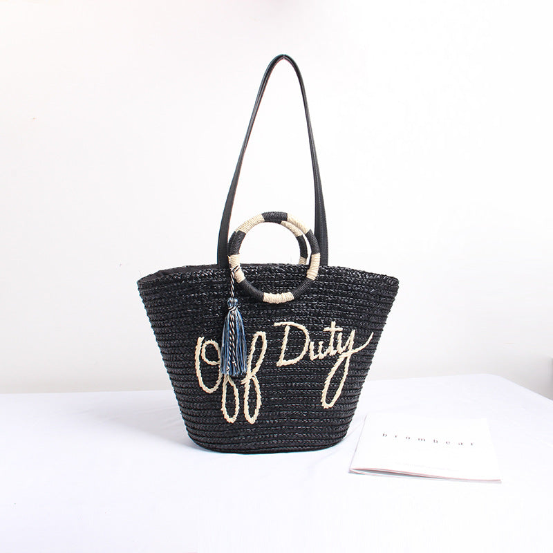 Designer shoulder bag with playful lettering and decorative tassel detail Bowlift