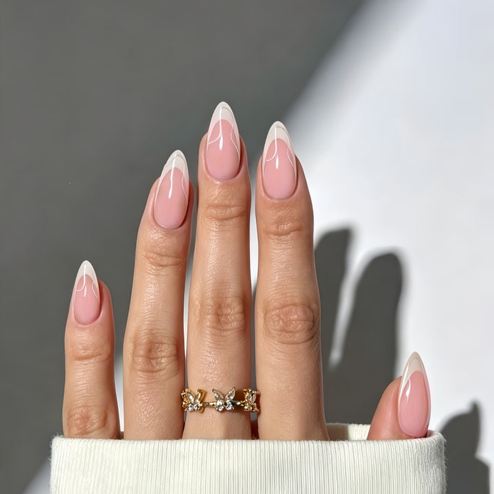 Artificial nails with elegant French design and curved accents Bowlift
