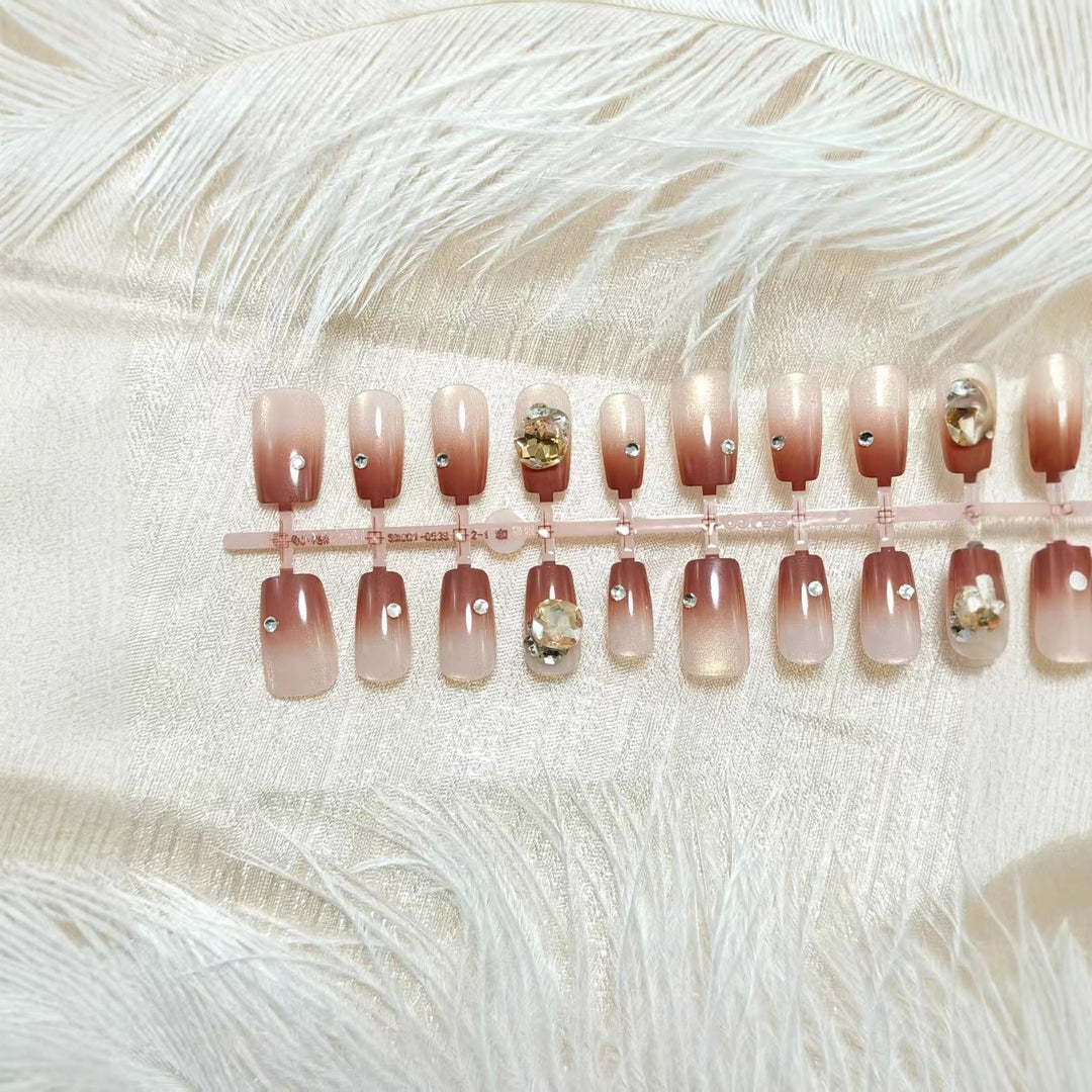 Artificials nails in elegant ombre style with rhinestone embellished applications Bowlift