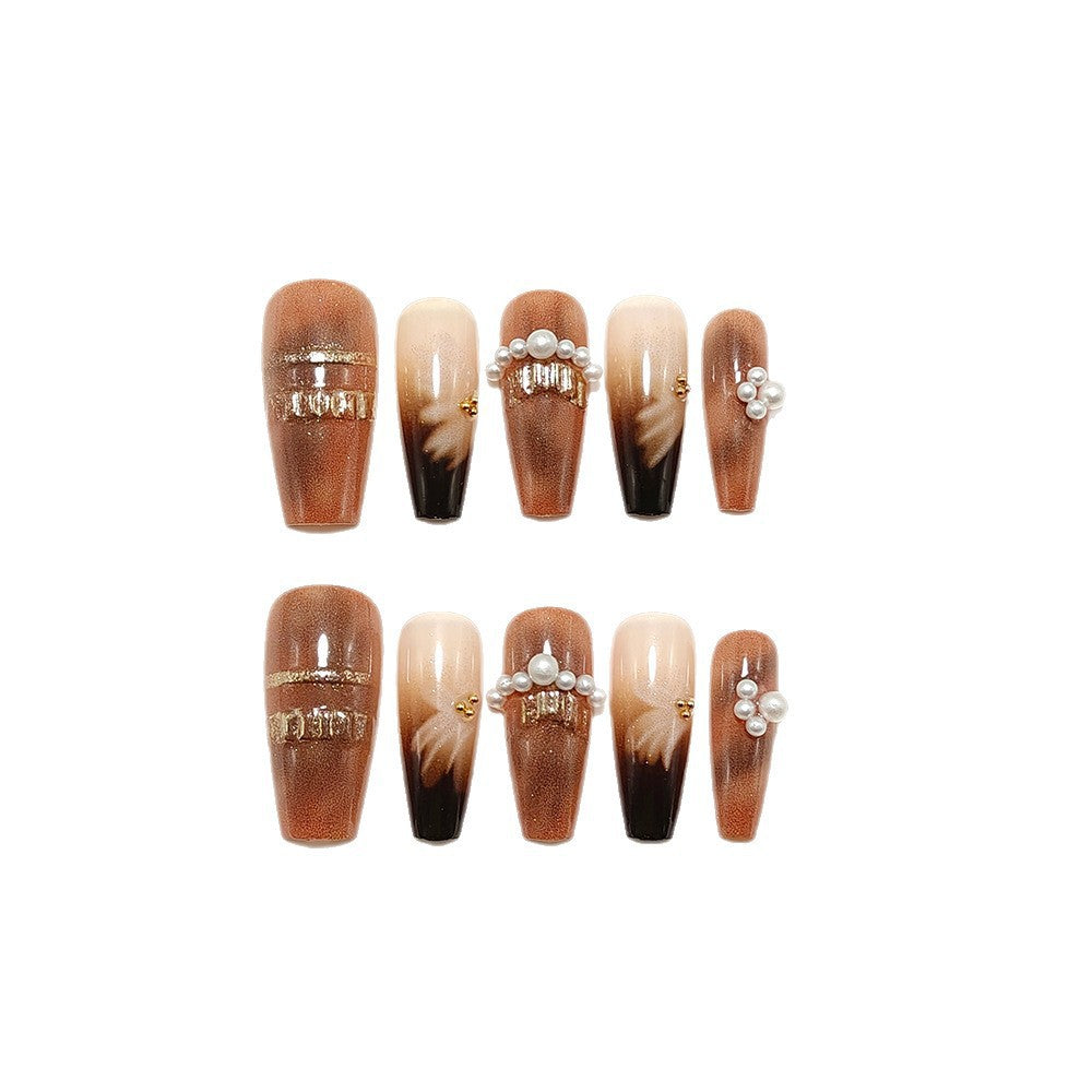 Artificial nails with glamorous gold and pearl embellished accents Bowlift