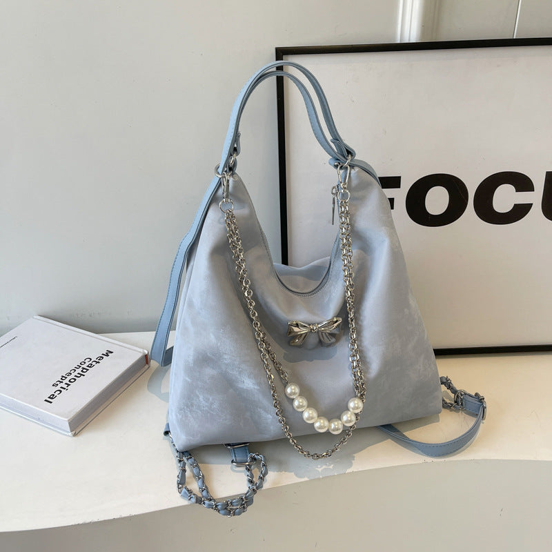 Fashionable handbag with unique pendant and chain accents Bowlift