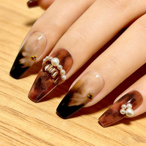 Artificial nails with glamorous gold and pearl embellished accents Bowlift