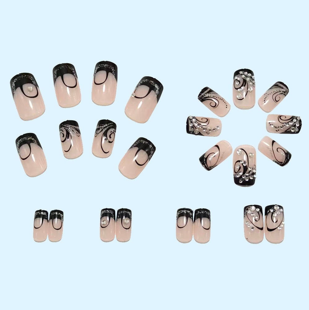 Artificial nails in elegant black-and-white design with glitter applications Bowlift