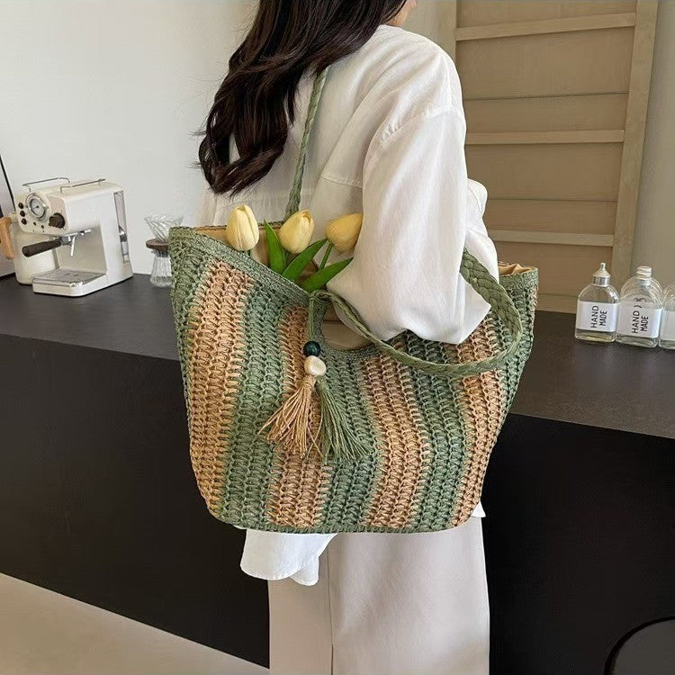 Handcrafted straw bag with elegant tassels and detailed texture Bowlift