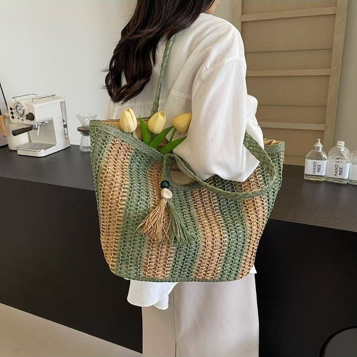 Handcrafted straw bag with elegant tassels and detailed texture Bowlift