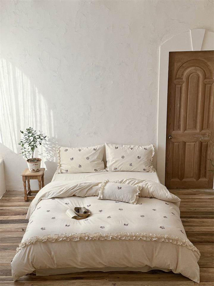 Cotton bedding set with embroidered floral motif and ruffled frills Bowlift