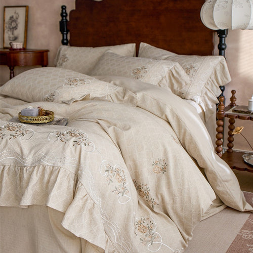 Romantic cotton bedding set with diamond jacquard, embroidered border, and gathered ruffle