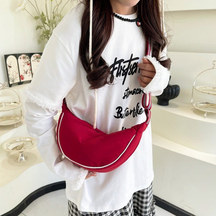 Fashionable shoulder bag with unique cut and adjustable strap Bowlift