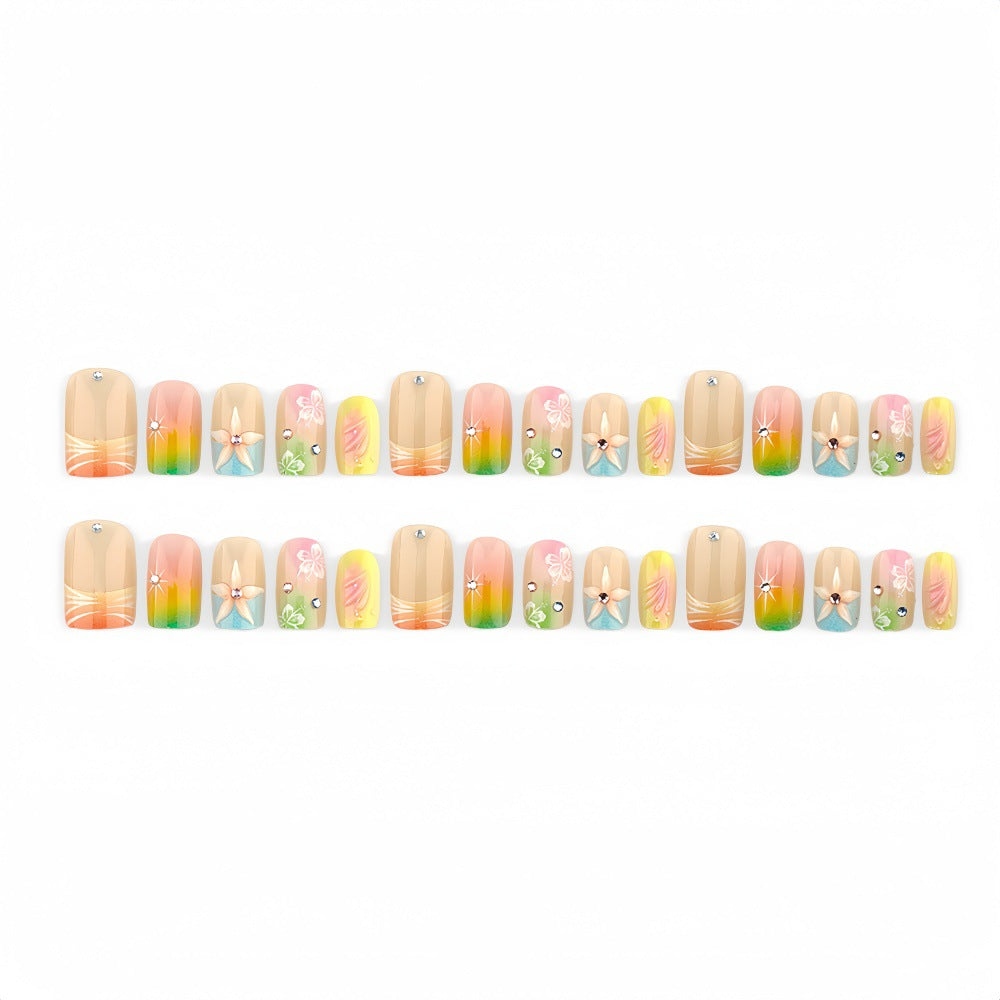Artificial nails in vibrant floral design with glitter accents Bowlift