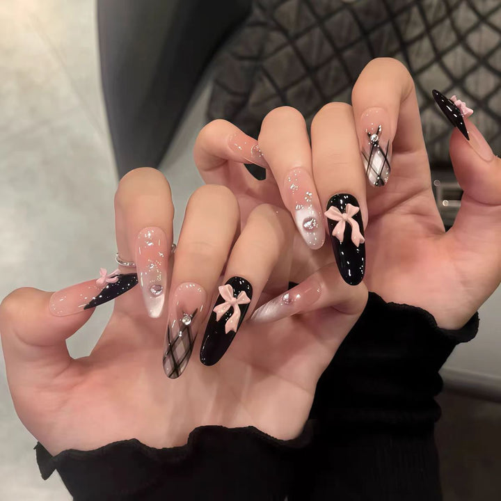 Artificial nails with playful bow design and glitter effects Bowlift