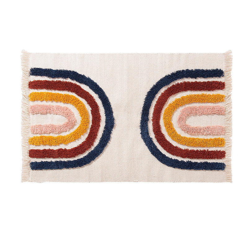 Hand-tufted cotton bath mat with botanical pattern and decorative fringes
