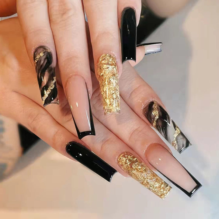 Acrylic nail set with luxurious golden accents and elegant designs Bowlift