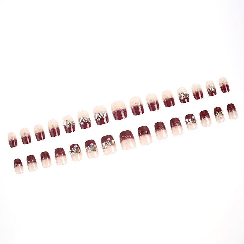 Glamorous artificial nails with decorative pearl and glitter embellishments Bowlift