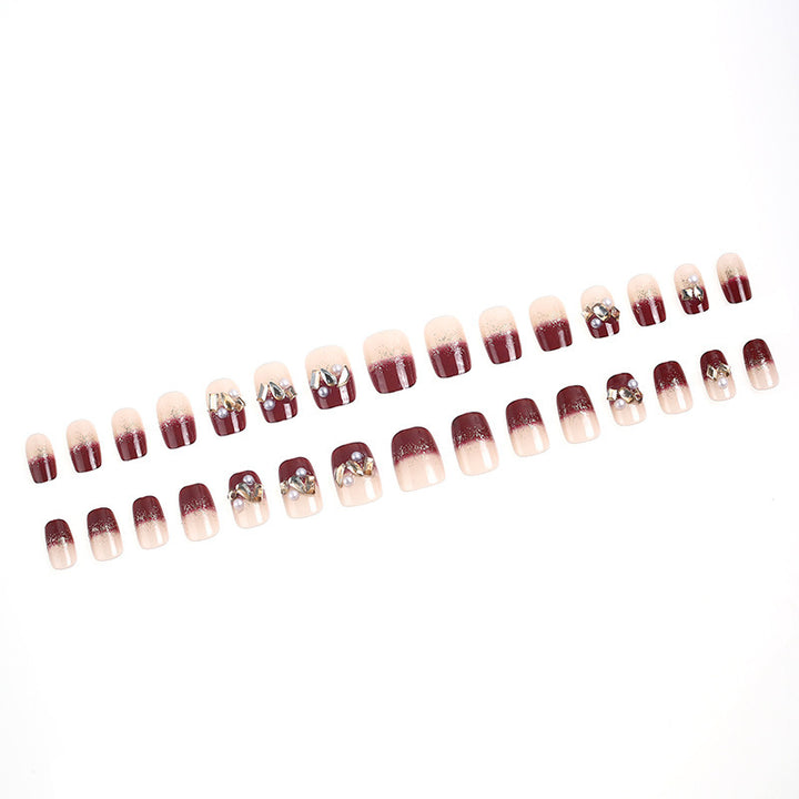 Glamorous artificial nails with decorative pearl and glitter embellishments Bowlift