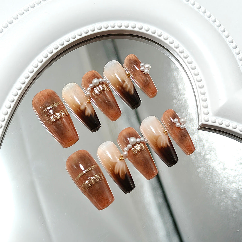Artificial nails with glamorous gold and pearl embellished accents Bowlift