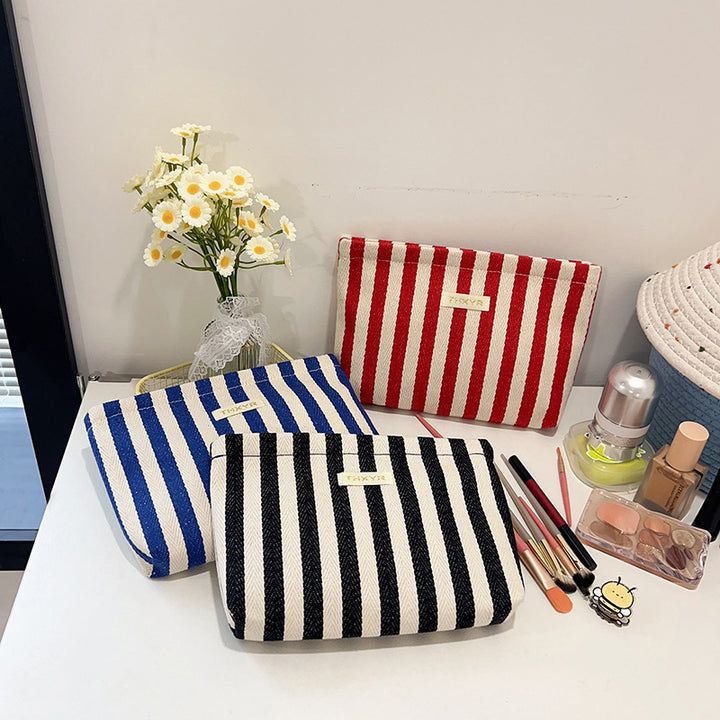 Striped canvas zippered cosmetic pouch clutch with padded lining and wristlet Bowlift