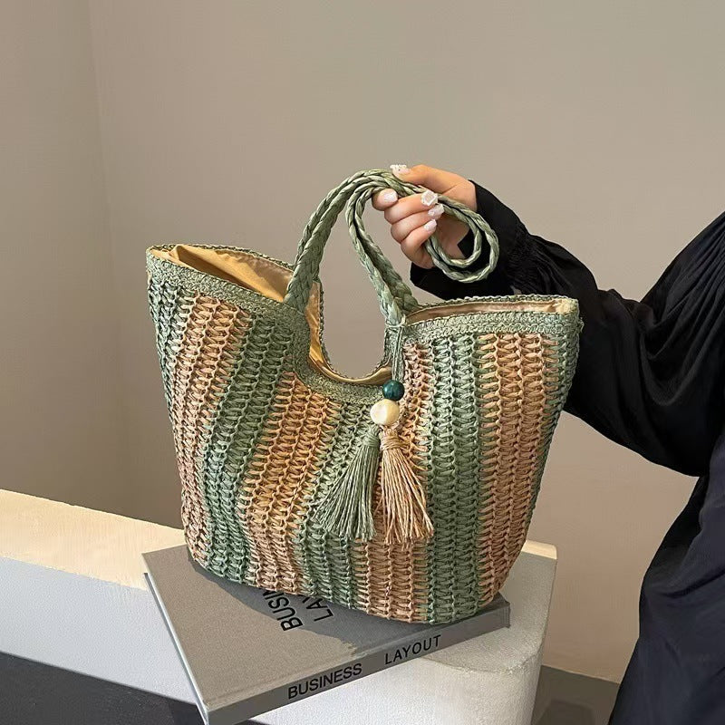 Handcrafted straw bag with elegant tassels and detailed texture Bowlift
