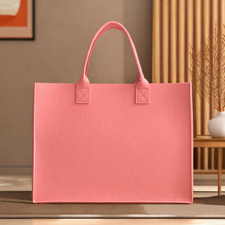 Structured felt tote bag with reinforced handles and organized interior Bowlift