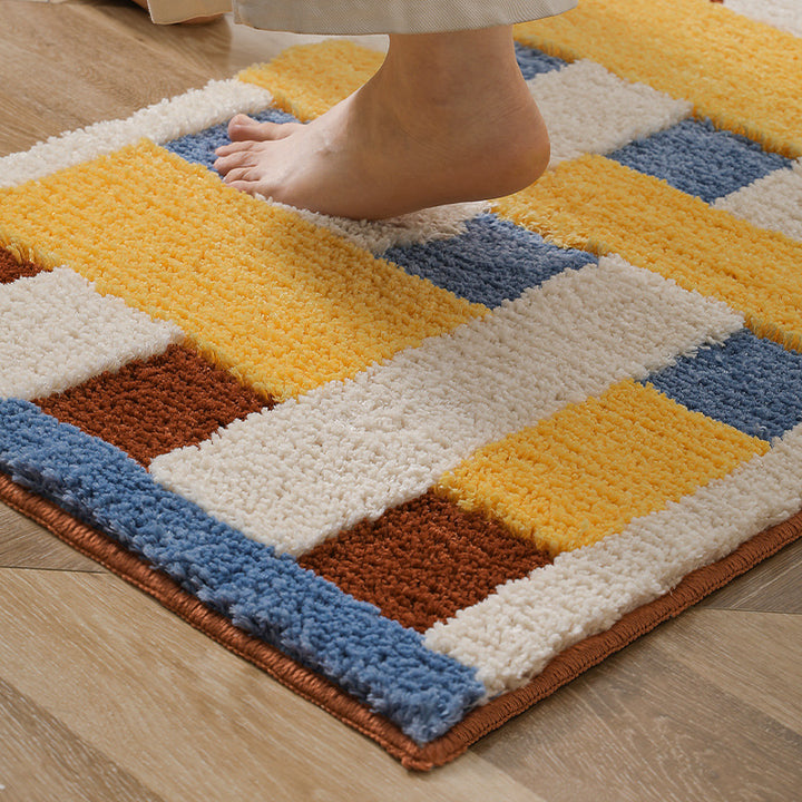 Rectangular tufted door mat with geometric block pattern and non-slip backing Bowlift