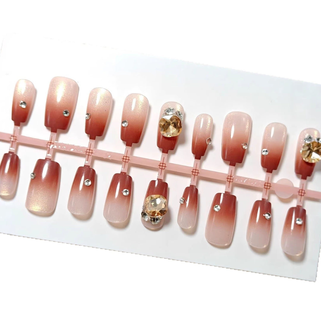 Artificials nails in elegant ombre style with rhinestone embellished applications Bowlift
