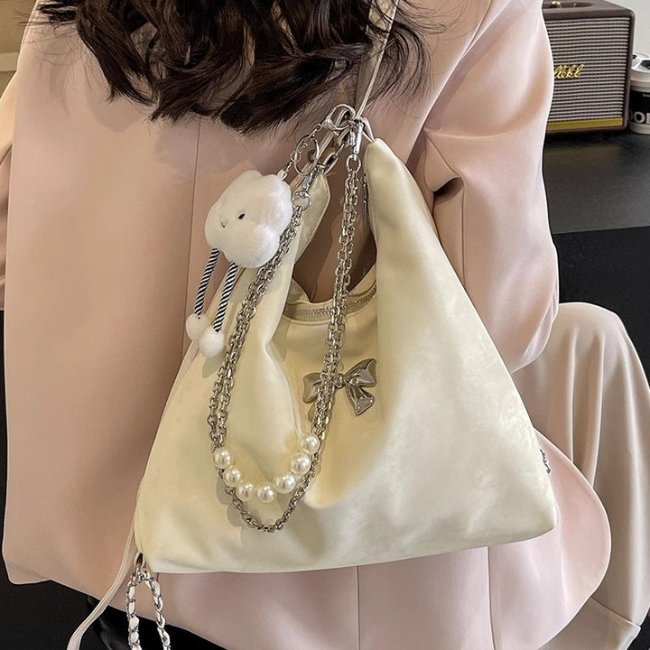 Fashionable handbag with unique pendant and chain accents Bowlift