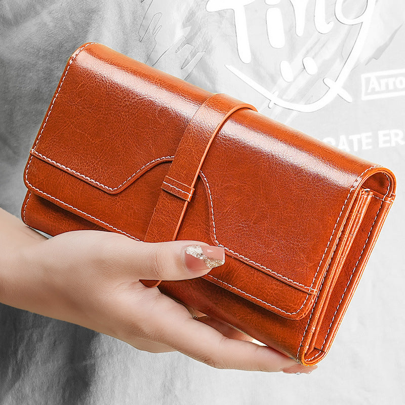 Premium leather long wallet clutch with strap closure and multiple card slots Bowlift