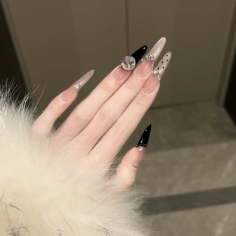Artificial nails in elegant design with glittering decorations Bowlift