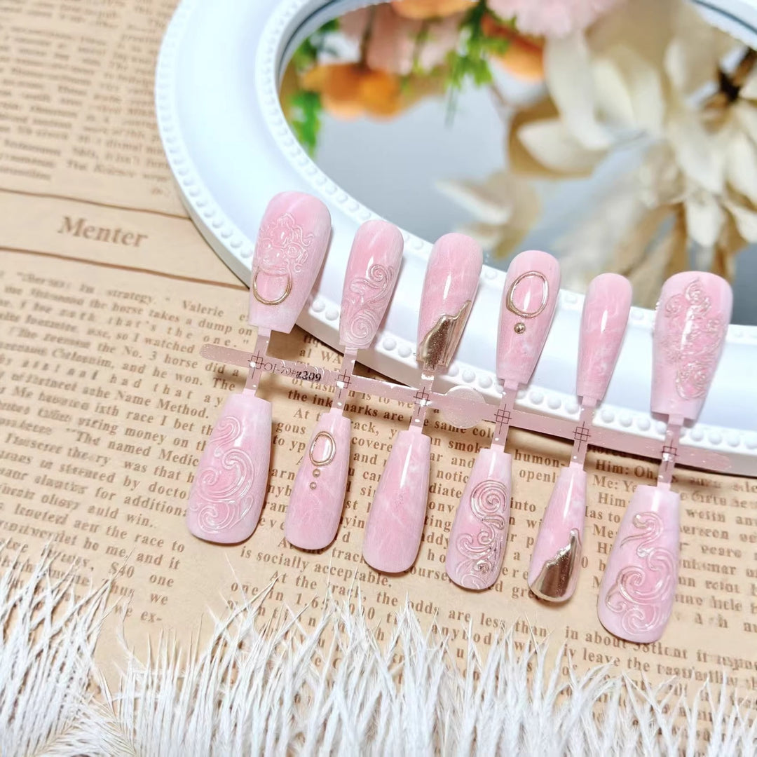 Artificial nails with elegant gold embellishments Bowlift