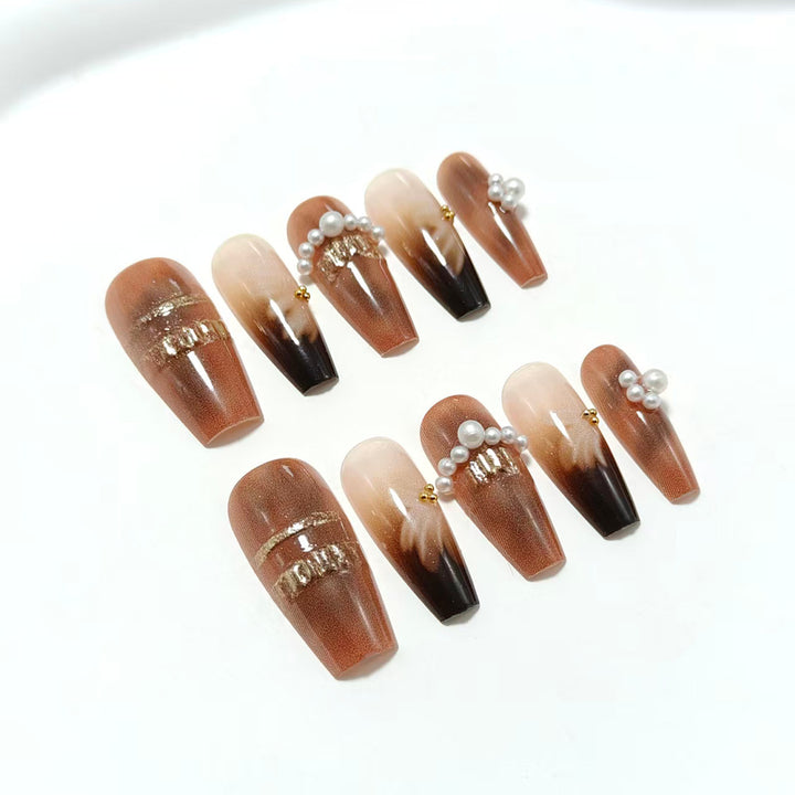 Artificial nails with glamorous gold and pearl embellished accents Bowlift