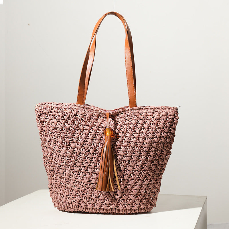 Handcrafted basket bag with fashionable tassel detail Bowlift