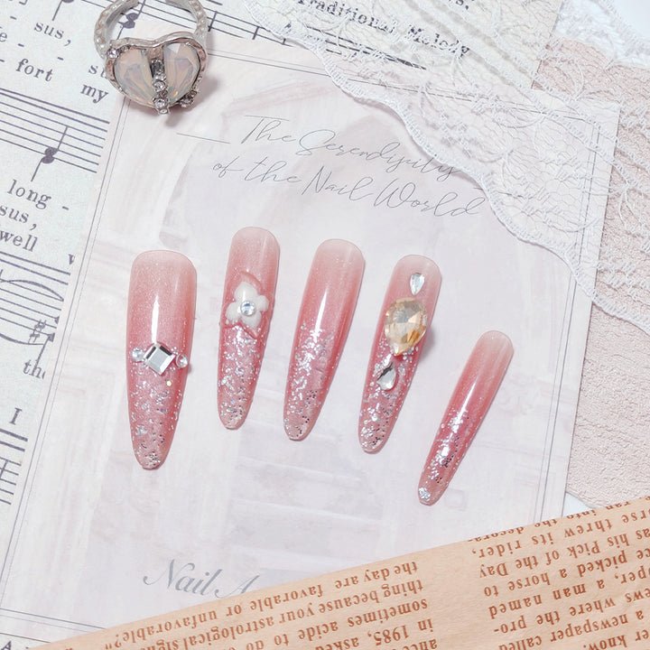 Artificial nail set with glitter and flower accents Bowlift