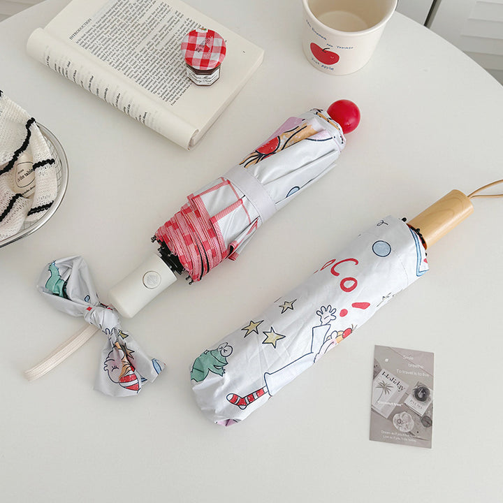Ladies folding umbrella with playful children's motif Bowlift