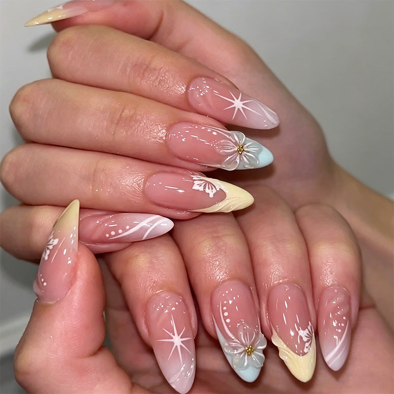 Artificial nail set with intricately detailed floral designs and shine accents Bowlift