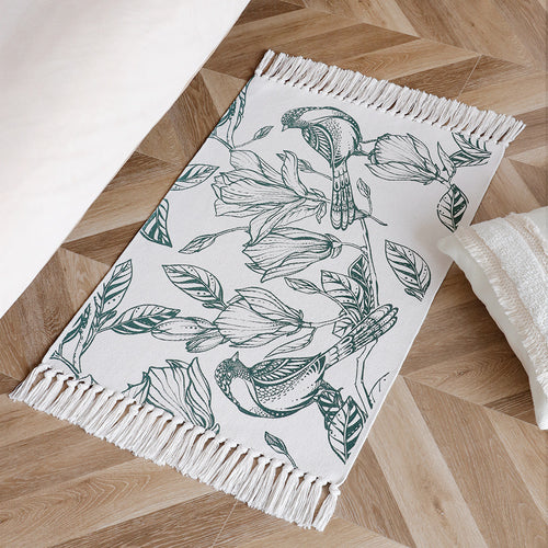 Woven table runner with botanical bird print and decorative fringes