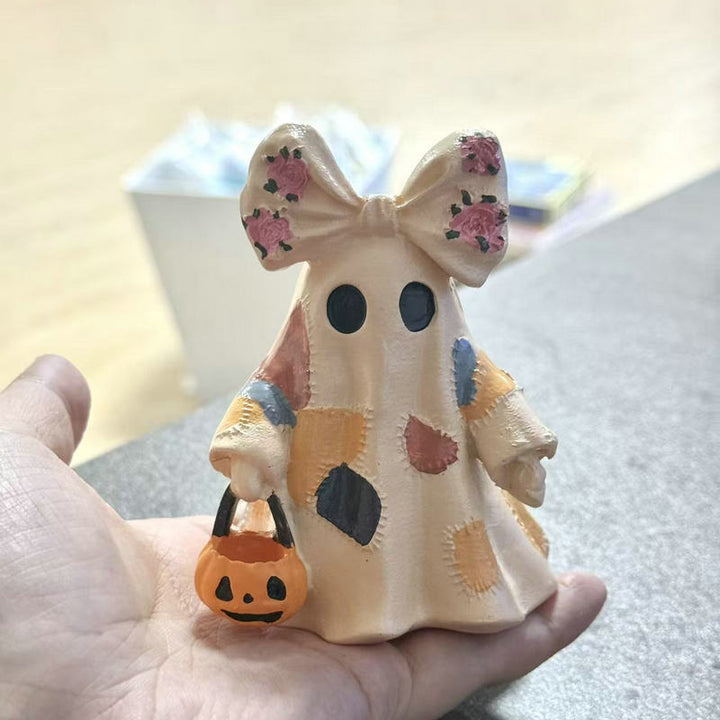 Ceramic ghost figure with integrated lighting and pumpkin basket