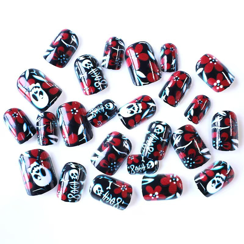 Creative nail art with skull motif and floral elements Bowlift
