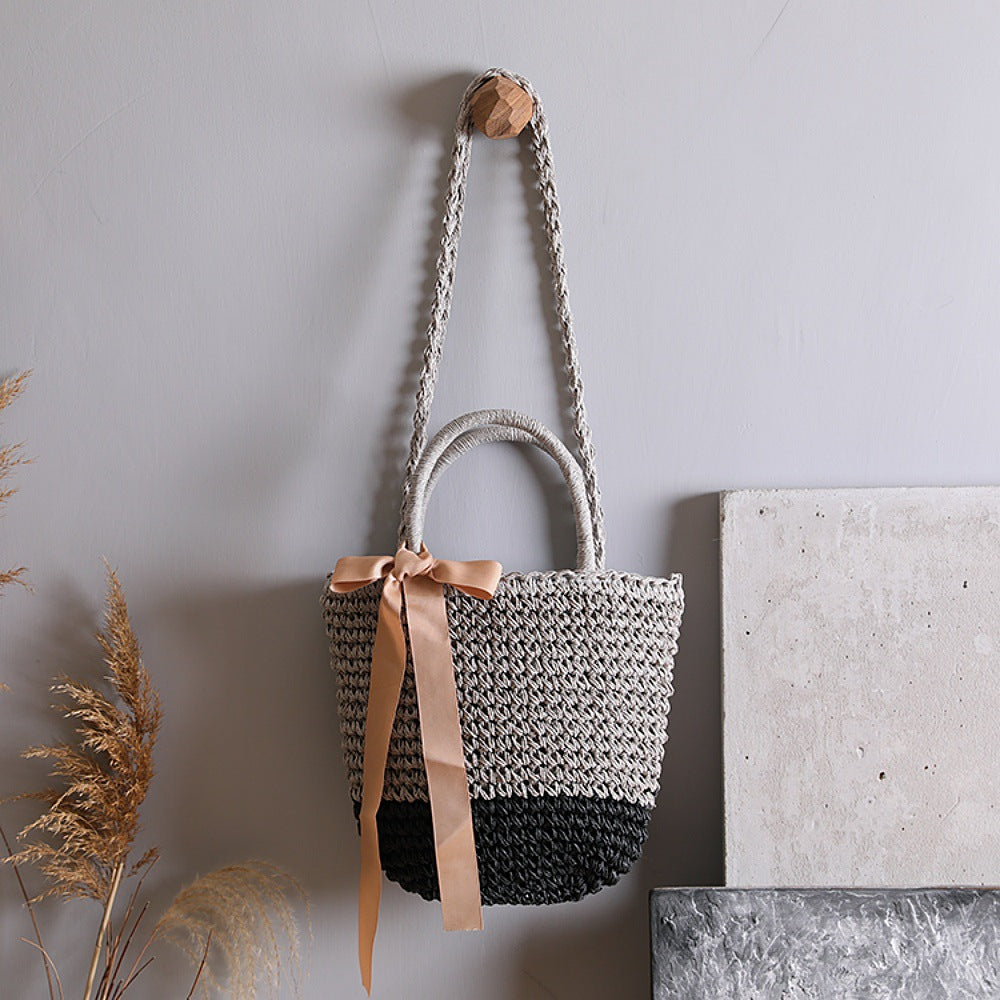 Basket bag with stylish carrying handles and decorative bow Bowlift