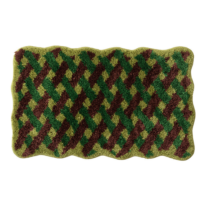 Tufted bathroom mat with wavy edge and geometric relief