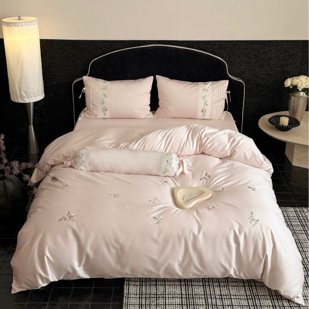 Luxurious satin bedding set with embroidered floral appliqués and bolster Bowlift