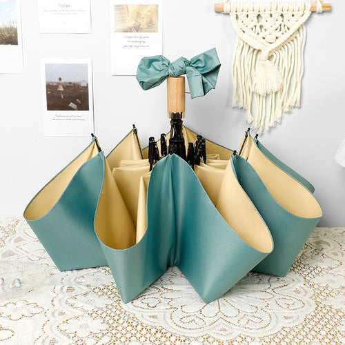 Ladies elegant folding umbrella in portrait format with stylish wooden handle Bowlift