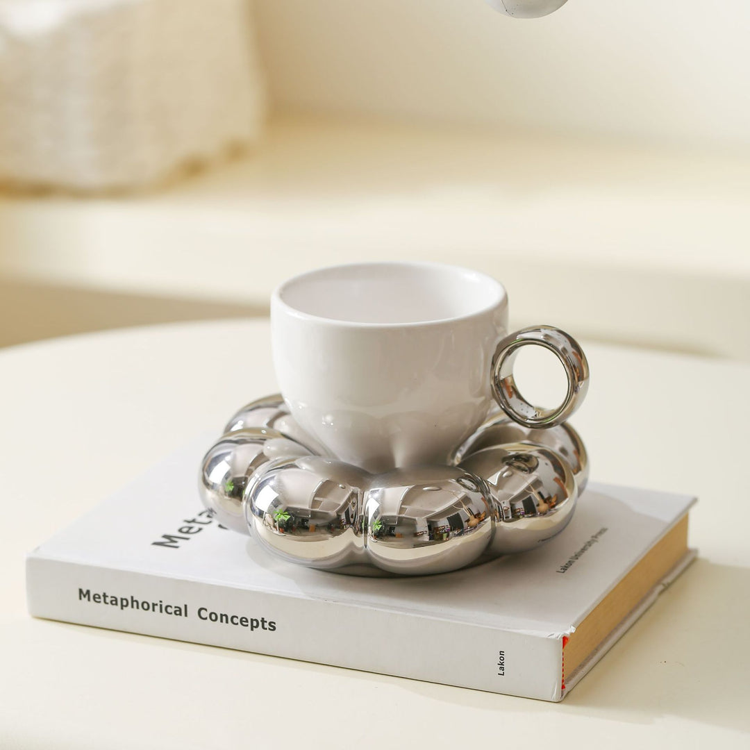 Ceramic mug with sculptural bubble saucer