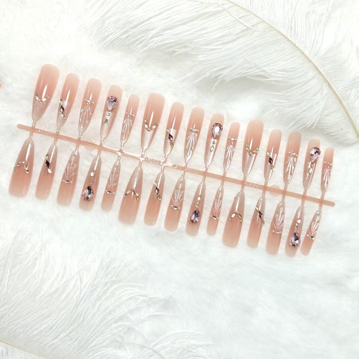 Artificial nails with glamorous crystal embellishments Bowlift