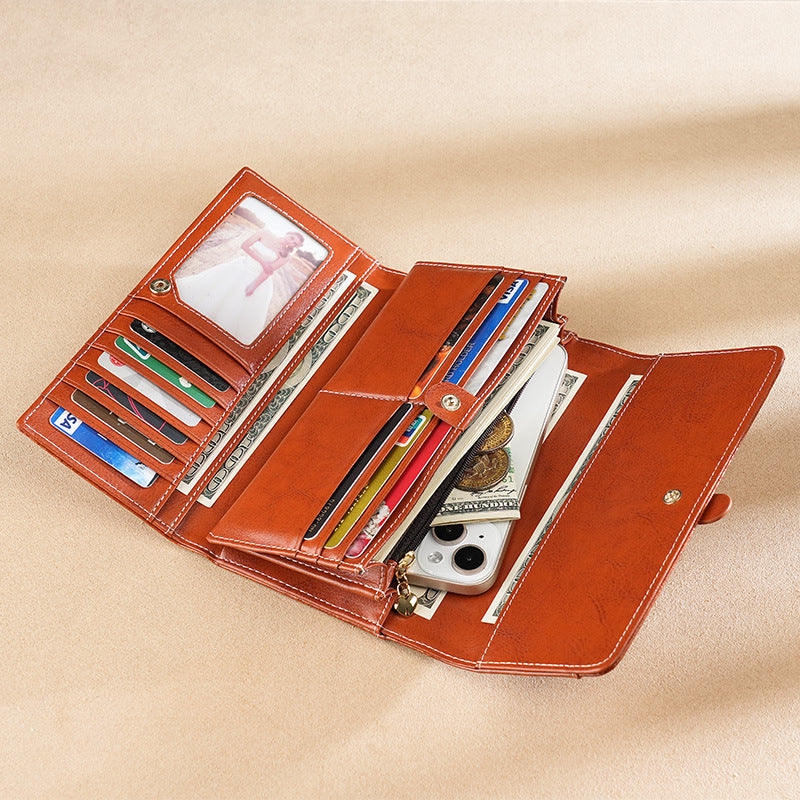 Premium leather long wallet clutch with strap closure and multiple card slots Bowlift