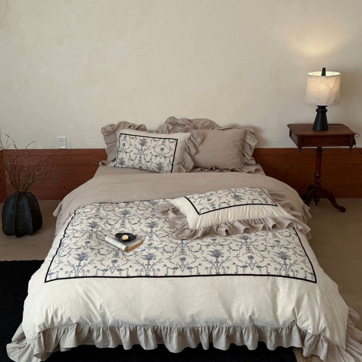 Romantic linen-look bedding set with ruffle, quilted center panel, and fine floral jacquard