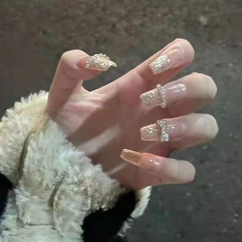 Glamorous artificial nails with sparkling rhinestone and glitter elements Bowlift