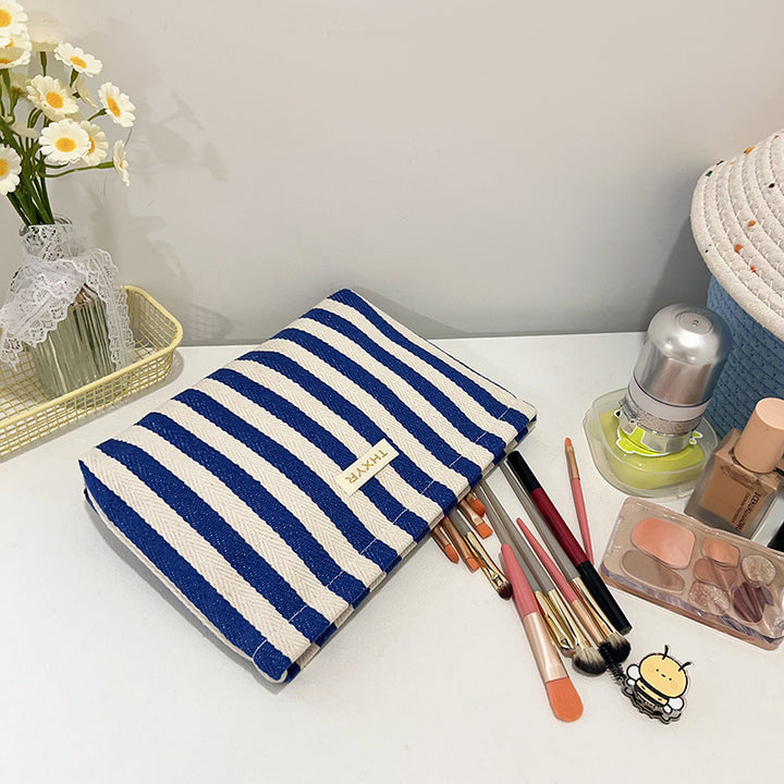 Striped canvas zippered cosmetic pouch clutch with padded lining and wristlet Bowlift